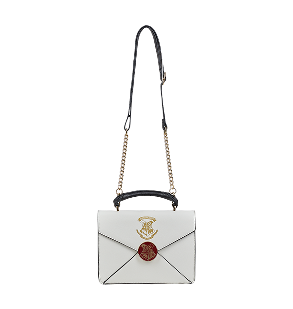 A cream-colored crossbody bag with an envelope design, featuring the Hogwarts school crest in metallic gold print, a metal burgundy clasp, and Harry Potter’s address printed in gold lettering.