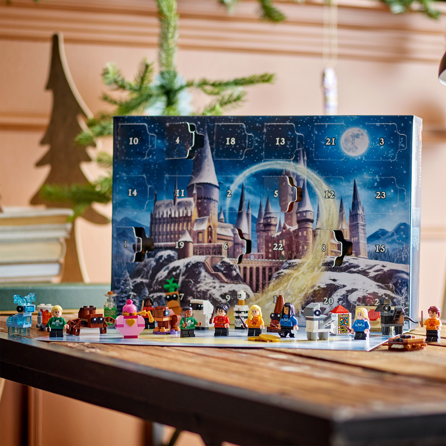 Advent calendar with Harry Potter theme on a table with Christmas decorations in the background