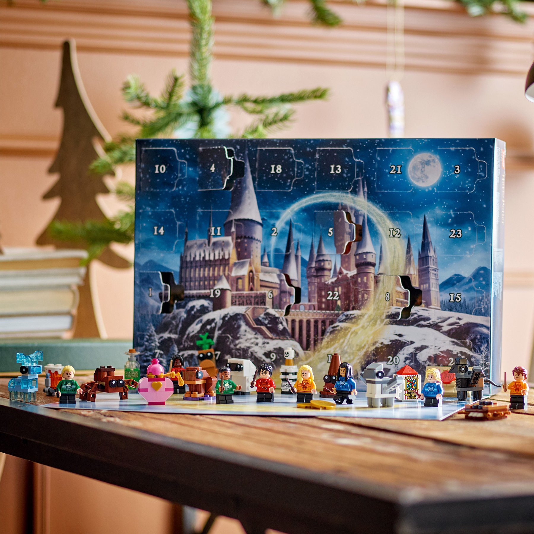 Advent calendar with Harry Potter theme on a table with Christmas decorations in the background