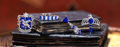 Ravenclaw jewelry set with blue and silver elements on a dark surface