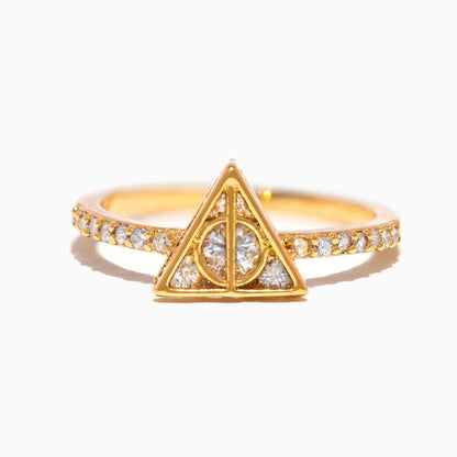 Gold ring with a triangular design and small diamonds on a white background