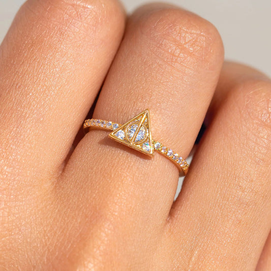 Rose gold ring with a triangular design on a finger