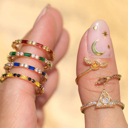 Close-up of fingers wearing colorful rings with a blurred background