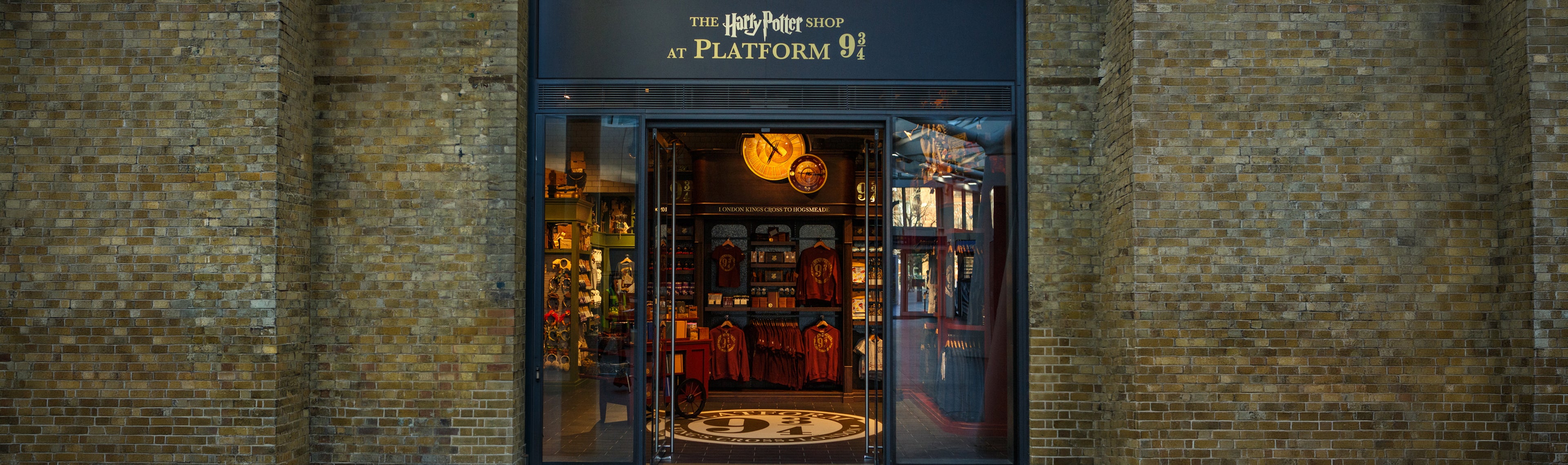 Kings Cross storefront with 'Harry Potter' branding on a brick wall background