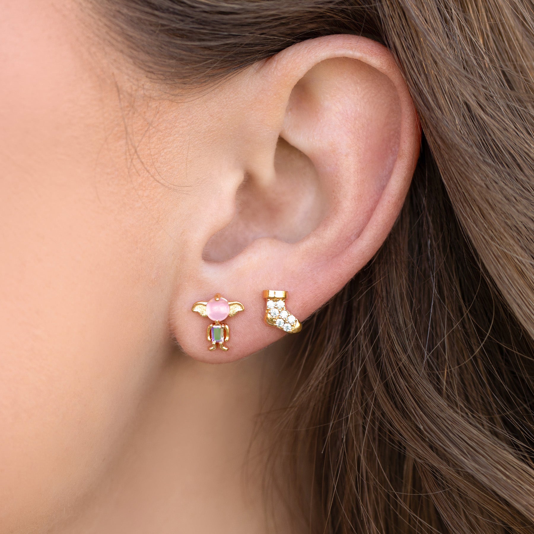 Close-up of an ear wearing colorful Dobby stud earrings