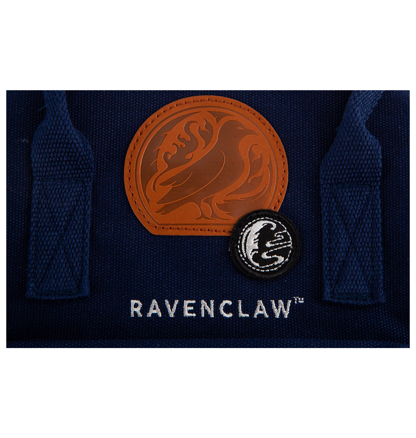 Navy blue fabric with 'Ravenclaw' badge and two embroidered logos on a white background
