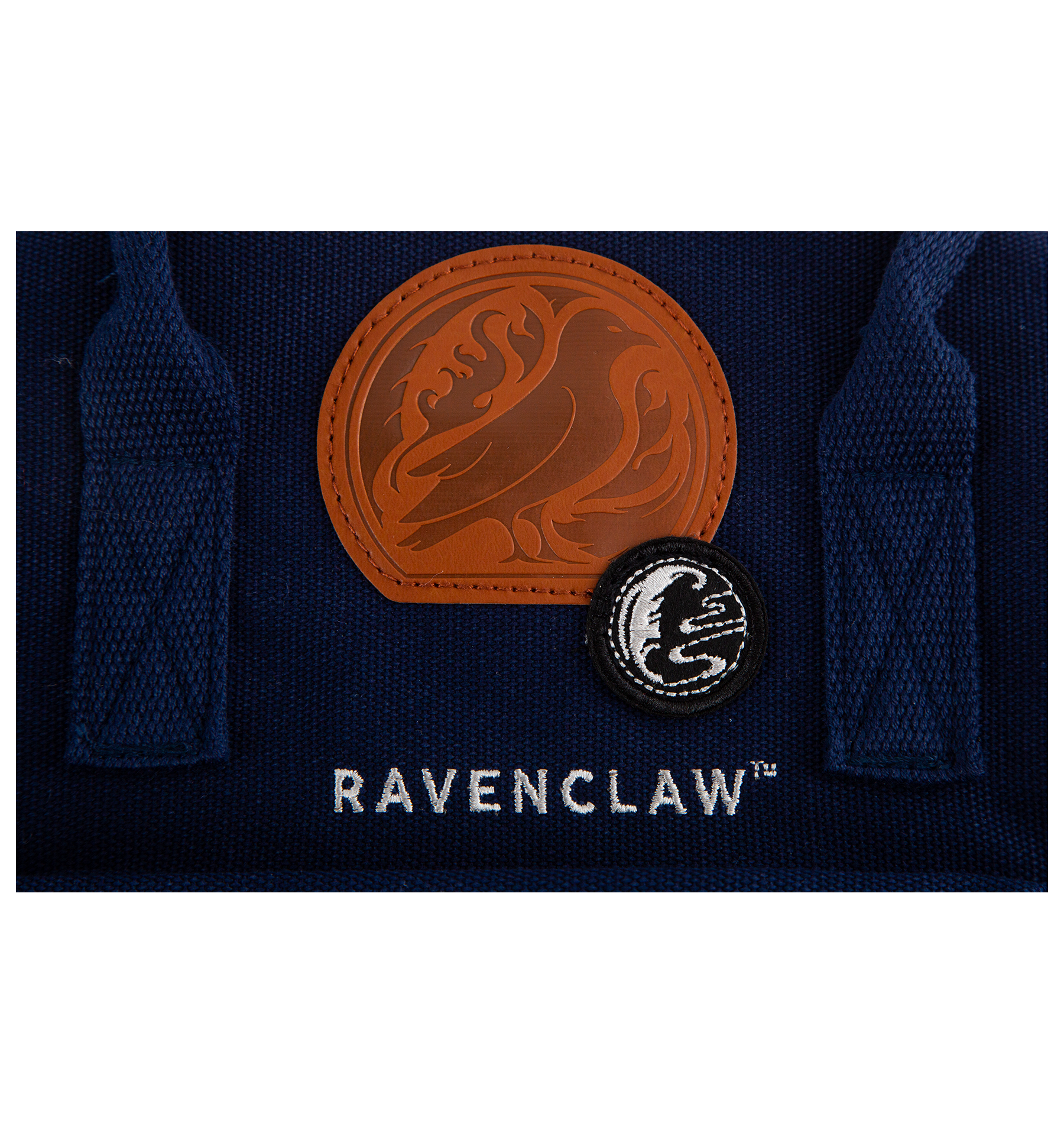 Navy blue fabric with 'Ravenclaw' badge and two embroidered logos on a white background