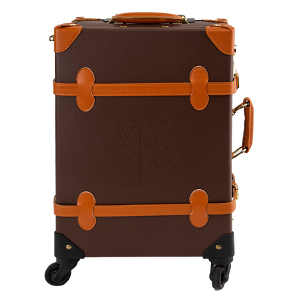 A brown travel case with orange handles and straps, featuring gold-plated clasps and a print of the Hogwarts house crest on the interior.